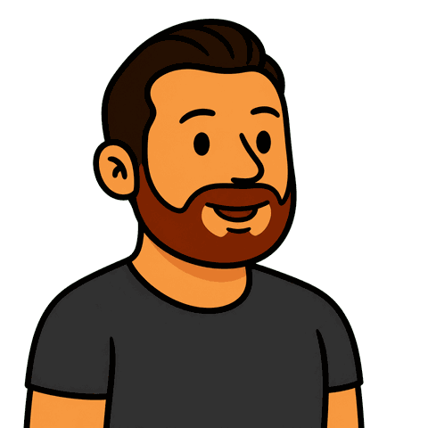 A man with brown hair and a beard wearing a dark grey shirt smiles.