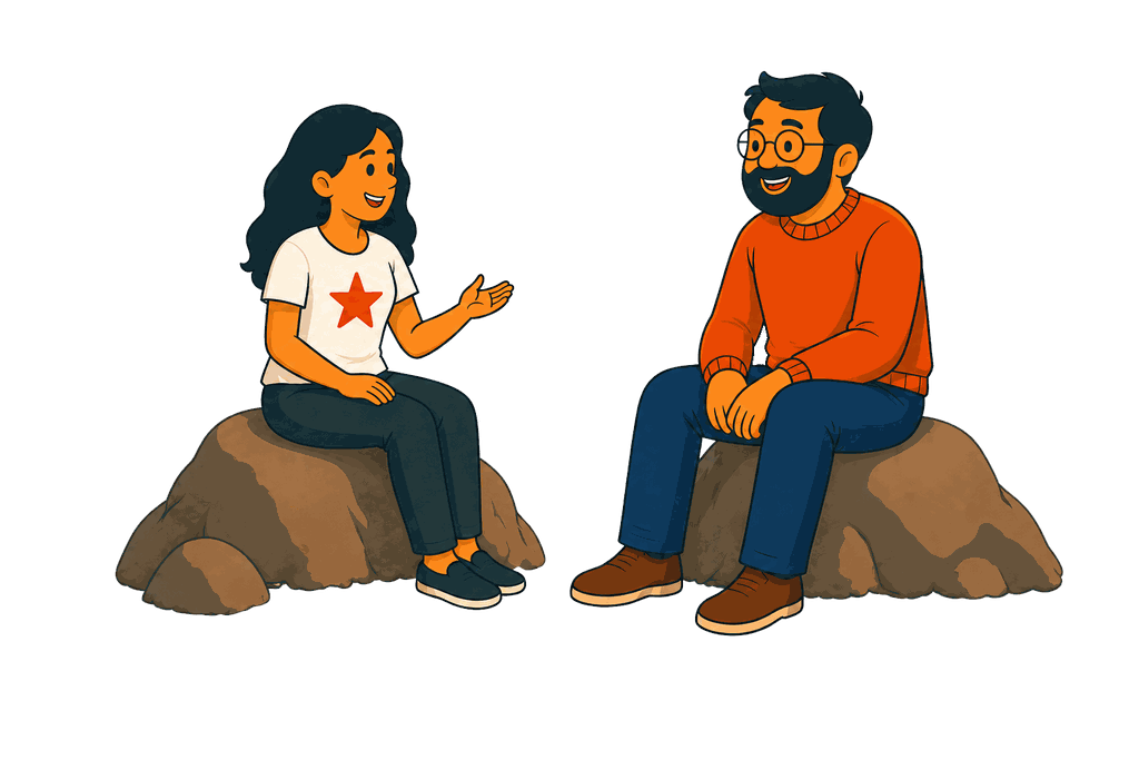 A woman in a white shirt with a red star sits on a rock talking to a man with glasses and a beard.